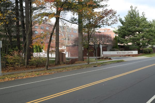 Exterior view of Whitney Center facility with fall foliage