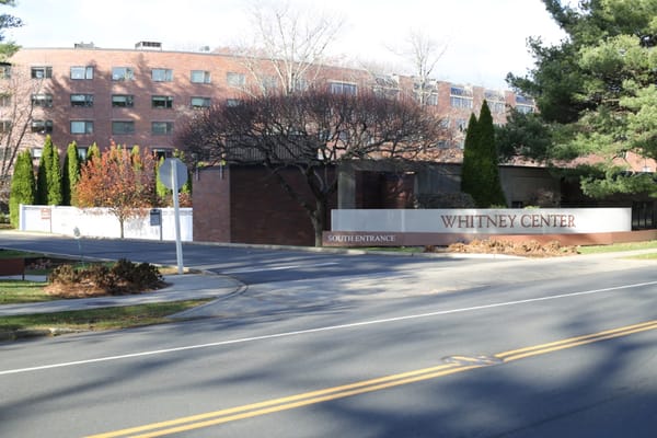 Exterior view of Whitney Center with entrance signage