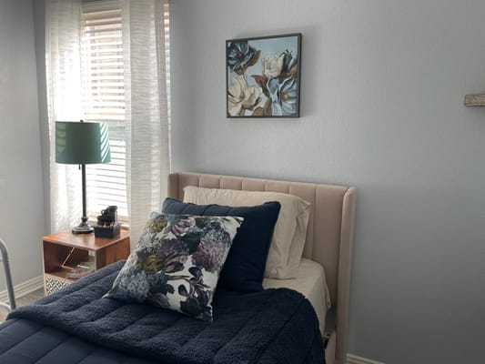 Cozy resident room with floral decor and bed