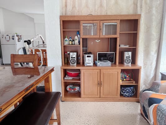 Wooden entertainment center in a common area of North Austin Senior Living