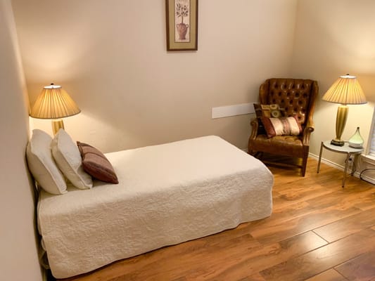 Cozy private room with a bed and chair