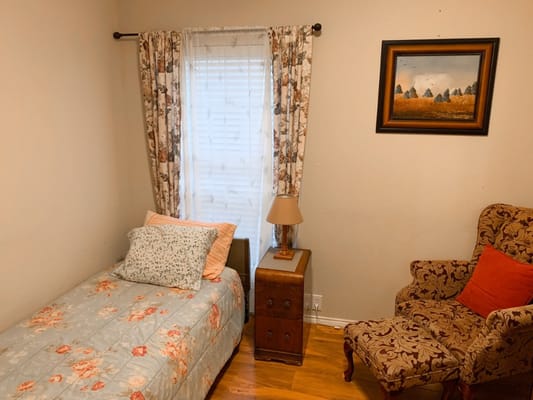 Cozy resident room with bed and chair