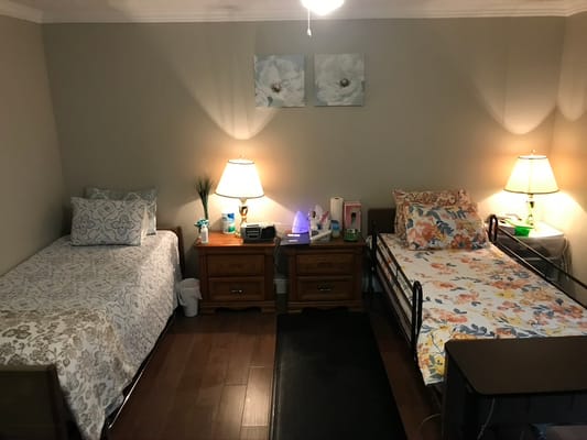 Cozy bedroom with two beds and bedside tables in a senior living facility