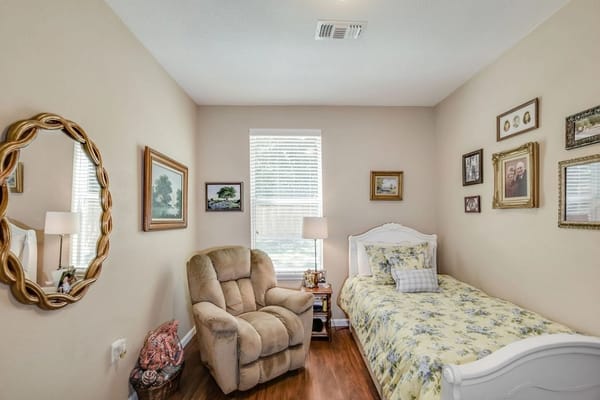 Cozy resident room with a bed and chair