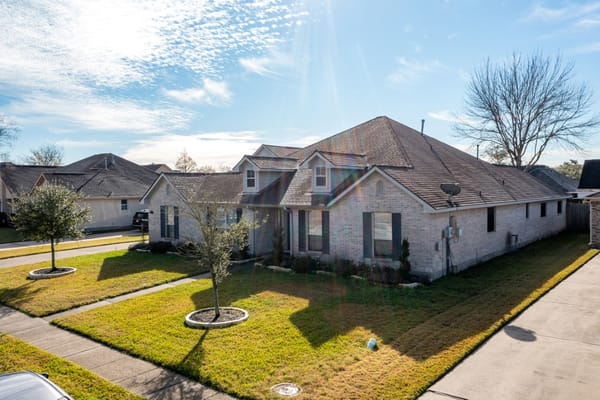 Exterior view of a single-story building and yard