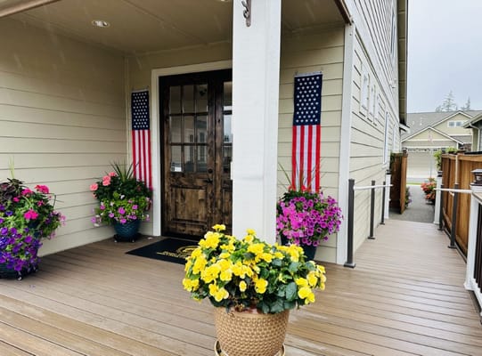 Front entrance of a senior care facility with flower pots