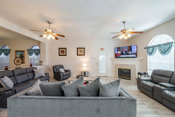 Bright common area with comfortable seating and a TV.