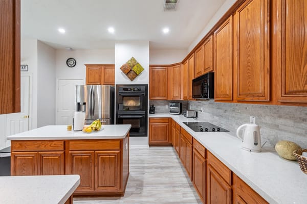 Bright kitchen area with wooden cabinets and modern appliances