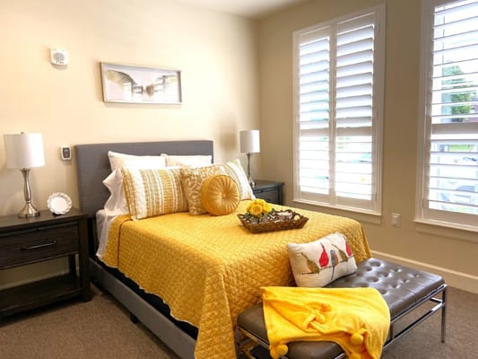 Cozy bedroom with yellow bedding and decorative pillows