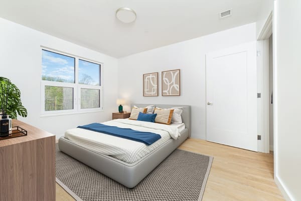 Bright and modern bedroom with a cozy bed and decor