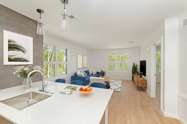 Bright common area with modern furnishings and large windows