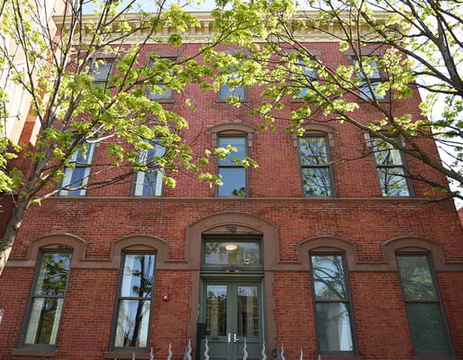 Front view of St. Bridget’s Senior Residence with trees in foreground