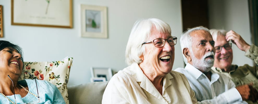 Residents enjoying laughter in a common area.