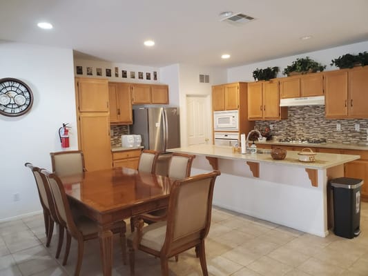 Bright kitchen area with a dining table and appliances