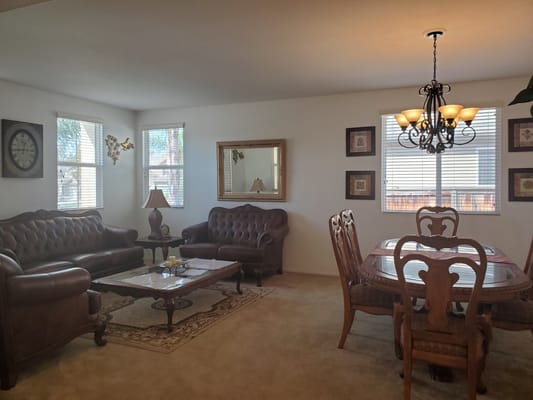 Bright common area with comfortable seating and dining table