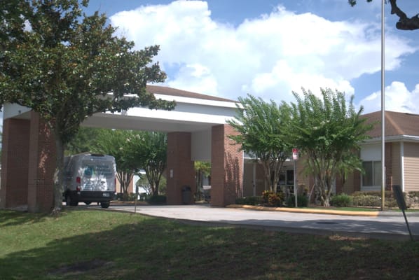 Building entrance with a van parked outside