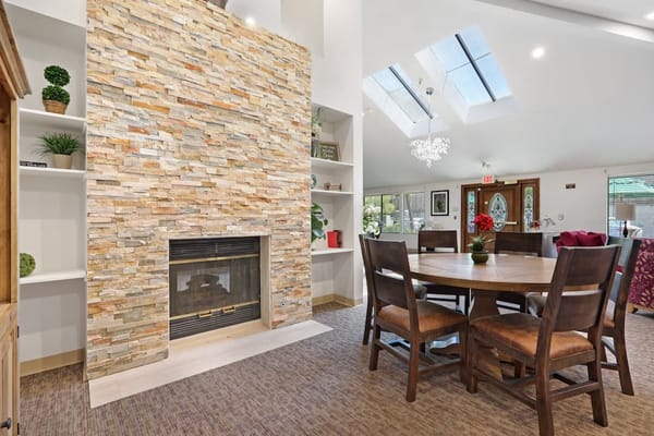 Interior view of a cozy common area with a stone fireplace