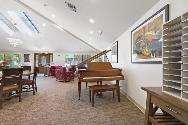 Bright common area with piano and seating