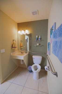 Well-lit bathroom with necessary amenities