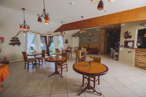 Bright dining area with tables and chairs