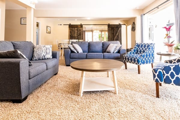 A cozy common area with sofas and chairs