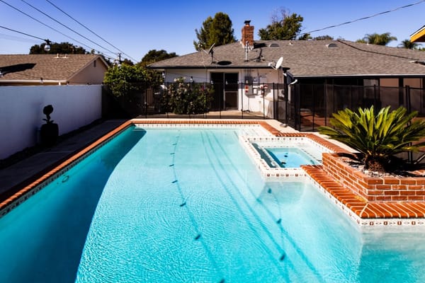Swimming pool area with patio and landscaping