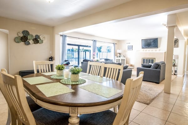 Bright common area with dining table and seating