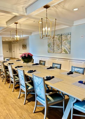 Long dining table with chairs and decorative lighting