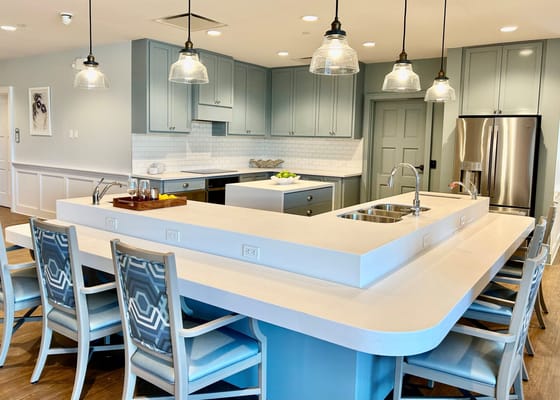 View of a modern kitchen with an island and seating area