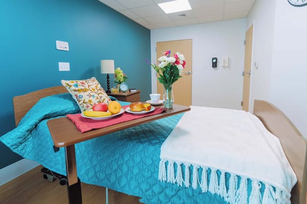 Bedroom setup with bed, fruits, and flowers