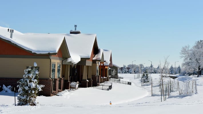 Exterior view of Columbine Patio Homes covered in snow