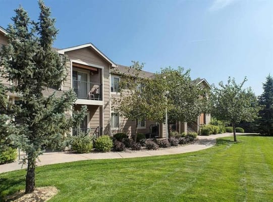 Exterior view of Reflections senior living facility with landscaped garden.