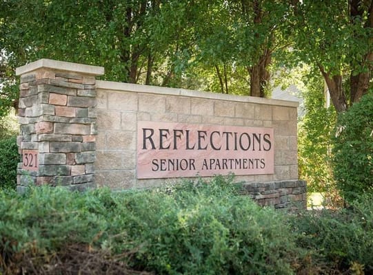 Sign for Reflections Senior Apartments at 321 E. Troutman Parkway.