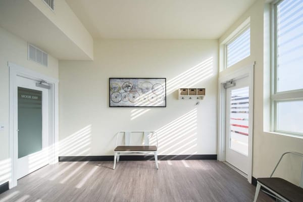 Modern lobby with a bench, wall art, and natural light