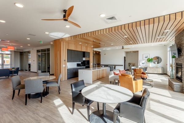 Bright, modern common area with seating and tables