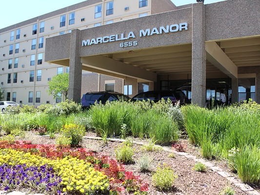 Exterior view of Marcella Manor with flowers
