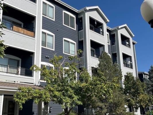 Exterior view of a senior living facility with trees