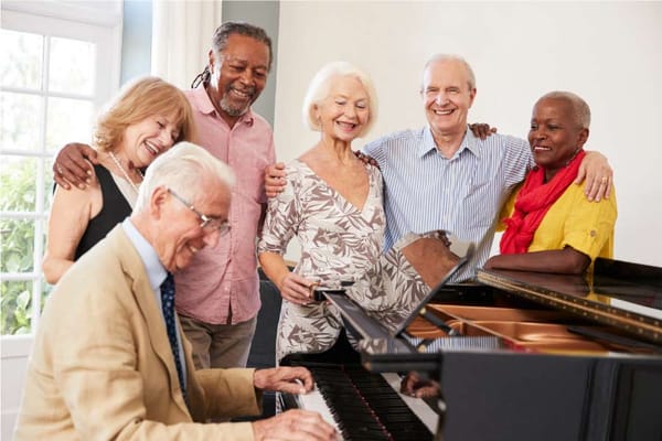 Residents and staff enjoying music together in a common area