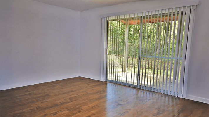 Interior view of an empty room with a sliding door to the outside