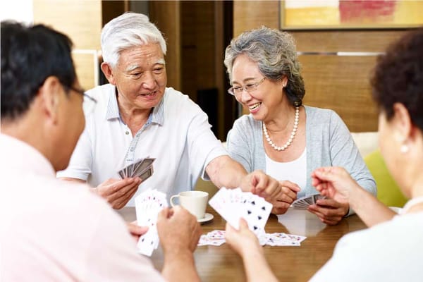 Residents enjoying a card game in a communal area