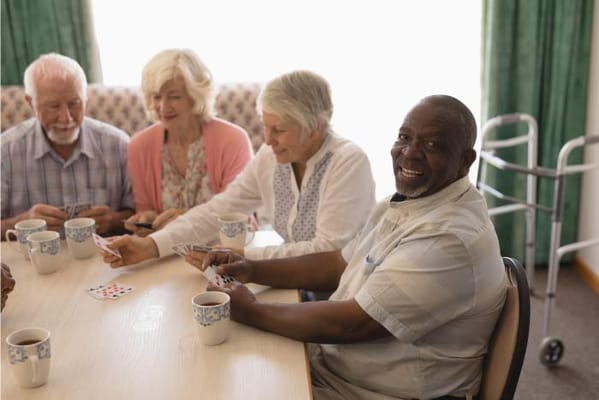 Residents enjoying a card game at a table