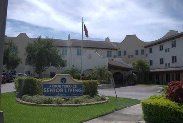 Main entrance of Arbor Terrace Citrus Park with sign and landscaped area.
