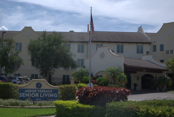 Entrance of Arbor Terrace Citrus Park senior living facility with landscaping.