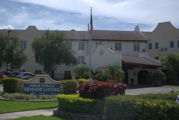 Front view of Arbor Terrace Citrus Park senior living facility with sign