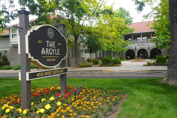 Sign of The Argyle with flowers in the foreground.