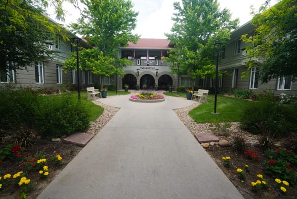 A beautifully landscaped courtyard featuring flower beds and pathways at The Argyle.