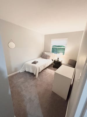 Cozy resident room with a bed and bedside table