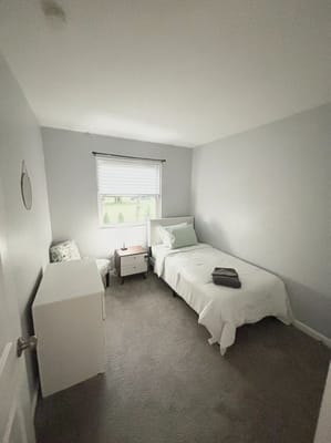 Cozy private resident room with a bed and chair