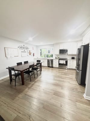 Bright kitchen with dining table and modern appliances