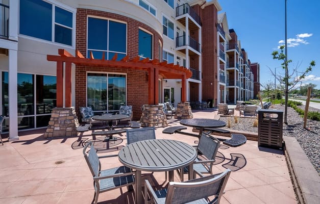 Outdoor patio area with seating at a senior living facility